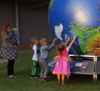 Picture of children with explorers globe at the museum